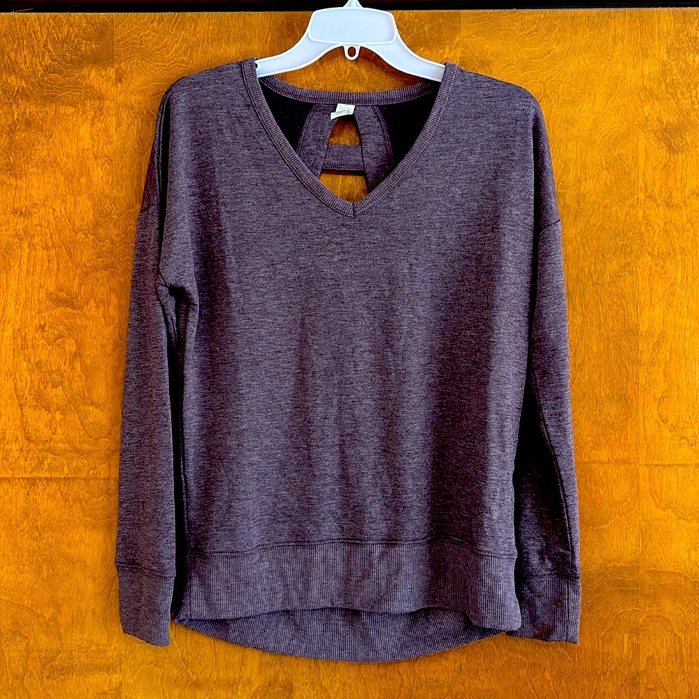 Thin sweater size small. Purple with cut out design in back